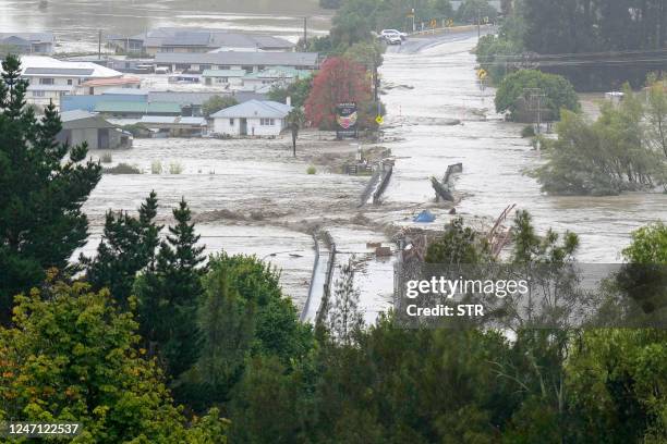 An aerial photo taken on February 14, 2023 shows the Waiohiki bridge and surrounds inundated by the Tutaekuri River after Cyclone Gabrielle made...
