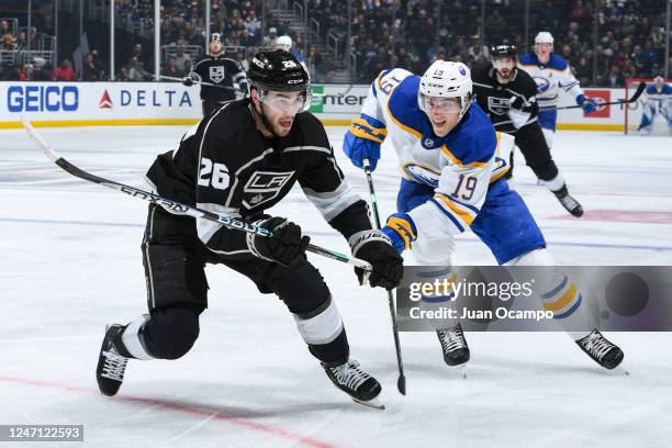 Sean Walker of the Los Angeles Kings and Peyton Krebs of the Buffalo Sabres battle for position during the second period at Crypto.com Arena on...