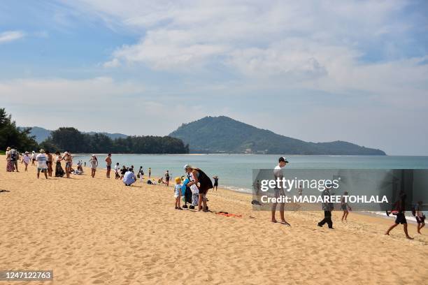 In this picture taken on February 13 tourists enjoy Mai Khao Beach in Phuket province.