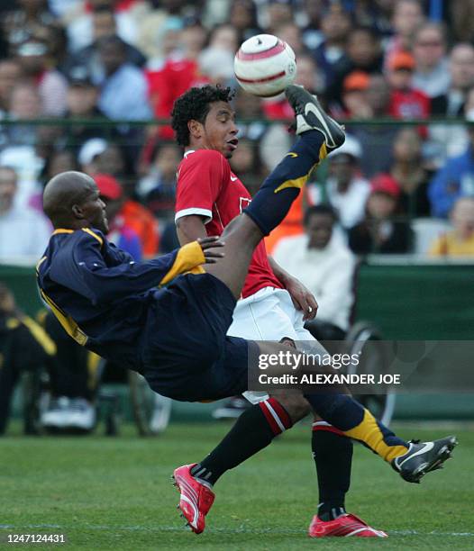 Kaizer Chiefs ' defender Cyril Nzama kicks the ball away from Manchester United Midfilder Kieron Richardson during the soccer Vodacom Challenge in...