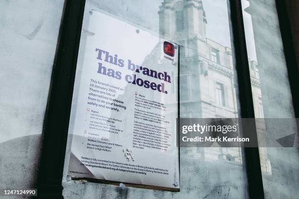 Notice indicating the closure of a branch of National Westminster Bank, commonly known as NatWest, is pictured on 10 February 2023 in London, United...