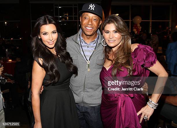 Kim Kardashian, Russell Simmons and Loren Ridinger attend Duane McLaughlin's "Ready To Live" album release party at Utopia III on September 10, 2011...