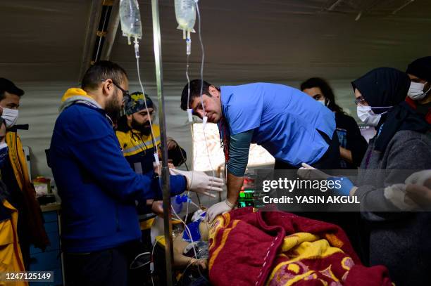 Graphic content / An injured victim is treated by rescuers at a field hospital in Hatay, on February 13 a week after an earthquake devastated parts...