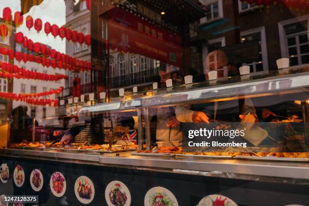 Customers serve themselves at the buffet in a Chinese restaurant in the Chinatown district of London, UK, on Wednesday, Feb. 2, 2023. Now with an...