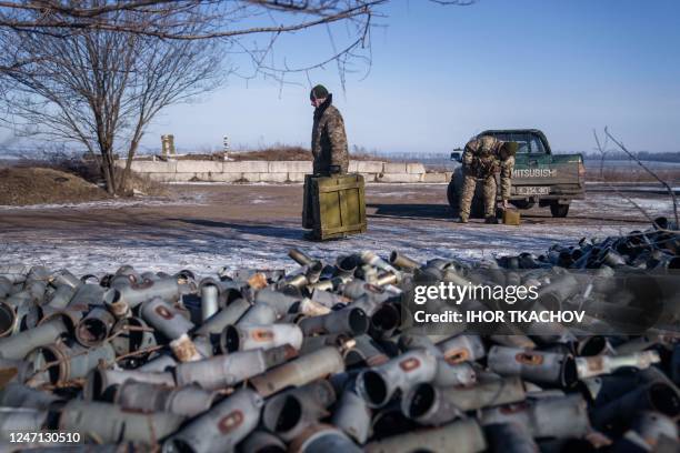 Helicopter crew member of the 18th Separate Army Aviation Brigade carries boxes of ammunition, in eastern Ukraine on February 9, 2023 amid Russia's...