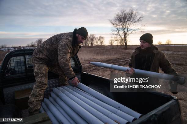 Members of the 18th Separate Army Aviation Brigade load ammunition in the back of a truck in eastern Ukraine on February 9 amid Russia's military...