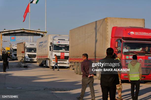 Trucks part of an aid convoy cross from Turkey into rebel-held north Syria through the Bab al-Salama crossing on February 14 after it reopened for UN...