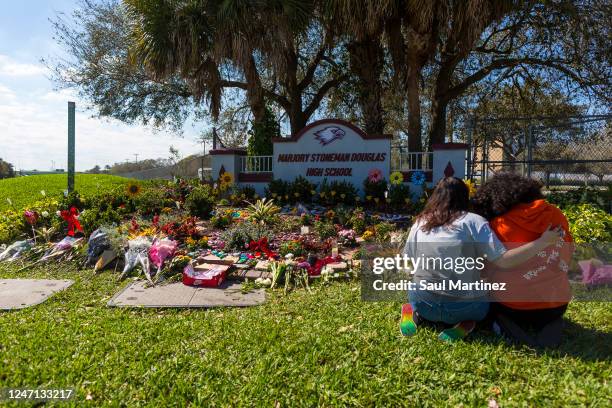 Two people embrace at a memorial at Marjory Stoneman Douglas High School to honor those killed on the 5th anniversary of the mass shooting on...