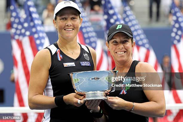 Liezel Huber and Lisa Raymond of the United States pose with the trophy after defeating Vania King of the United States and Yaroslava Shvedova of...