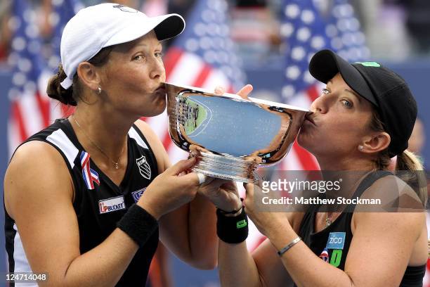 Liezel Huber and Lisa Raymond of the United States kiss the trophy after defeating Vania King of the United States and Yaroslava Shvedova of...