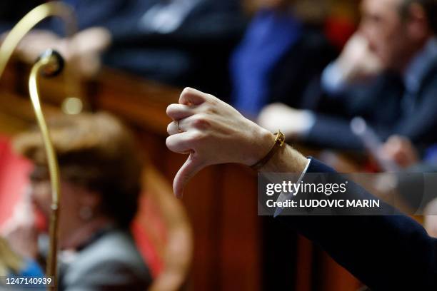 Member of parliament gives a thumbs down during a vote by show of hands to vote against an amendment to the pension reform bill, during a session to...