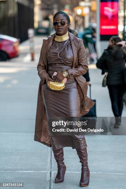 Amanda Finesse is seen wearing a coat and boots by Fashion Nova , dress by Express, necklace by Amazon, sunglasses by Dolce & Gabbana, a handbag by...