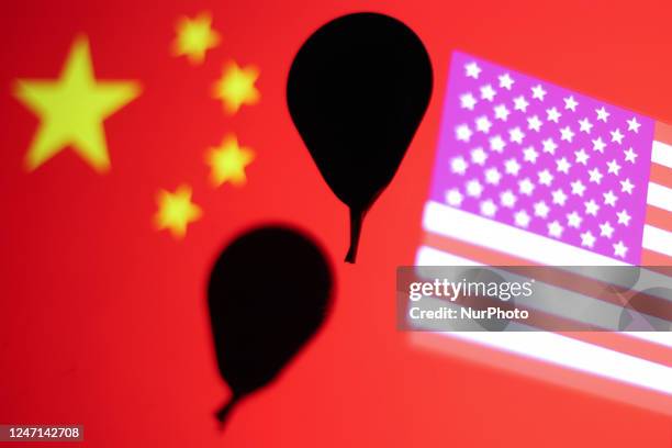 Baloon models are seen with Chinese and Americans flags displayed on screens in this multiple exposure illustration photo taken in Krakow, Poland on...