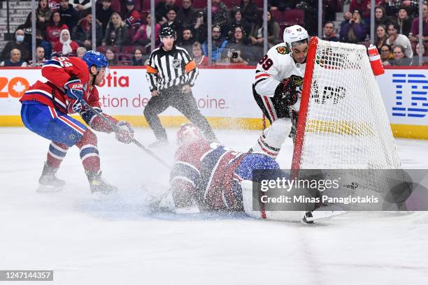 Andreas Athanasiou of the Chicago Blackhawks crashes into the net of goaltender Jake Allen of the Montreal Canadiens during the first period at...