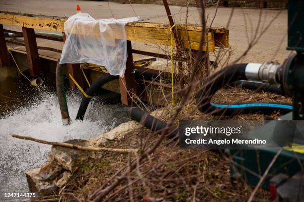 Water is pumped into a creek for aeration on February 14, 2023 in East Palestine, Ohio. A train operated by Norfolk Southern derailed on February 3,...