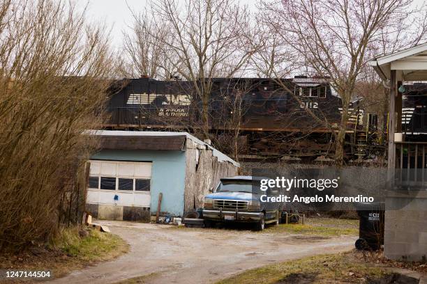 Norfolk Southern train runs behind homes on February 14, 2023 in East Palestine, Ohio. Another train operated by the company derailed on February 3,...