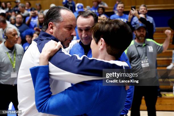 Former Duke head coach Mike Krzyzewski listens to wife Mickie Krzyzewski and head coach Mike Brey of the Notre Dame Fighting Irish talk prior to the...