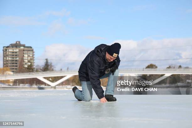 Bruce Devine, senior manager facilities and programs at the National Capital Commission checks the ice condition on the Rideau Canal on February 8,...