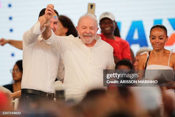 Brazil's President Luiz Inacio Lula da Silva shows a key during a ceremony to deliver new houses in Santo Amaro, Bahia state, Brazil, on February 14,...