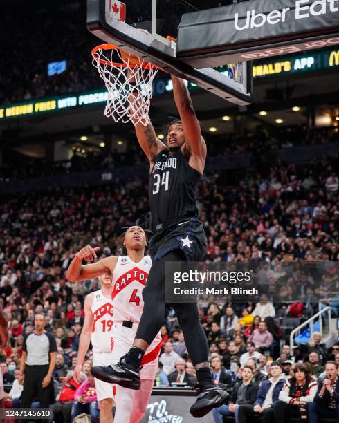 Wendell Carter Jr. #34 of the Orlando Magic goes up for a slam dunk against Scottie Barnes of the Toronto Raptors during the first half of their...