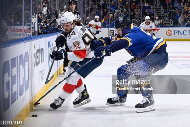 Colton Parayko of the St. Louis Blues defends against Ryan Lomberg of the Florida Panthers at the Enterprise Center on February 14, 2023 in St....