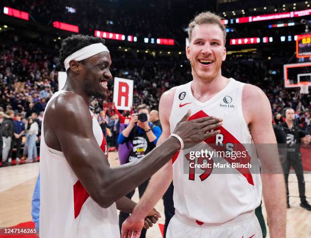 Jakob Poeltl and Pascal Siakam of the Toronto Raptors celebrate after they defeated the Orlando Magic in their basketball game at the Scotiabank...