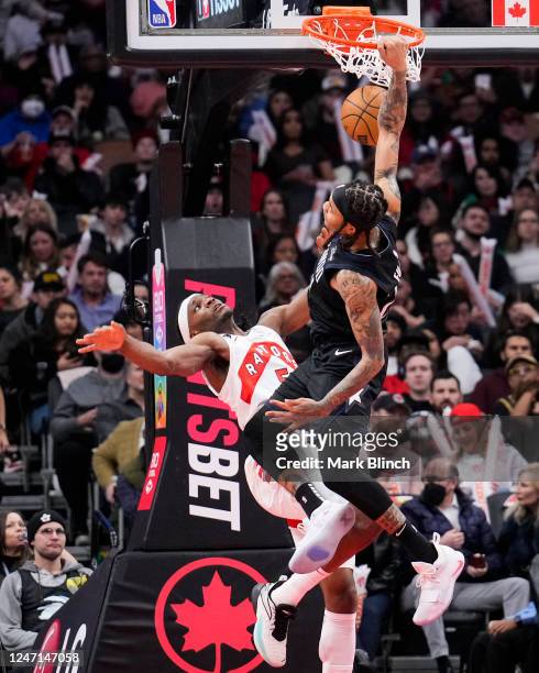 Markelle Fultz of the Orlando Magic dunks against Precious Achiuwa of the Toronto Raptors during the second half of their basketball game at the...