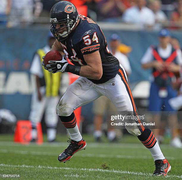 Brian Urlacher of the Chicago Bears runs for a touchdown after picking up a fumbled ball against the Atlanta Falcons at Soldier Field on September...