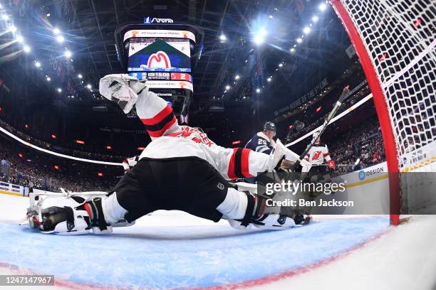 Goaltender Vitek Vanecek of the New Jersey Devils blocks a shot taken by Patrik Laine of the Columbus Blue Jackets during the second period of a game...