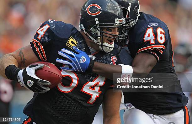 Brian Urlacher and Chris Harris of the Chicago Bears celebrate Urlacher's touchdown run against the Atlanta Falcons at Soldier Field on September 11,...