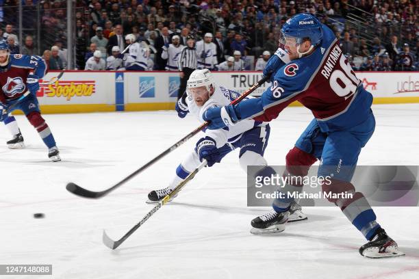 Mikko Rantanen of the Colorado Avalanche takes a shot while defended by Steven Stamkos of the Tampa Bay Lightning at Ball Arena on February 14, 2023...