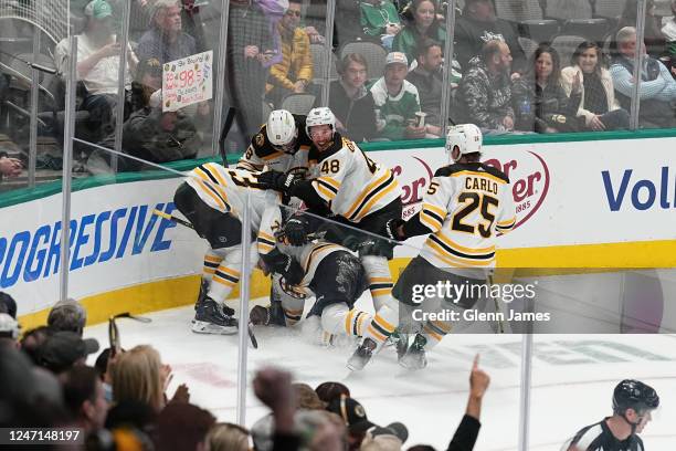 The Boston Bruins celebrate a game-winning goal against the Dallas Stars at the American Airlines Center on February 14, 2023 in Dallas, Texas.