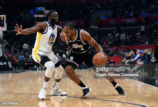 Kawhi Leonard of the Los Angeles Clippers drives against Draymond Green of the Golden State Warriors during the first half at Crypto.com Arena on...
