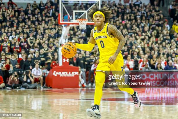 Michigan guard Dug McDaniel brings the ball up court during a college basketball game between the University of Wisconsin Badgers and the University...