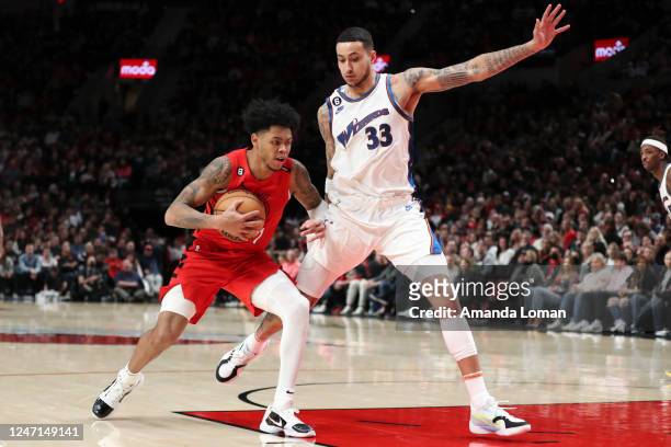 Anfernee Simons of the Portland Trail Blazers drives to the basket as Kyle Kuzma of the Washington Wizards defends during the third quarter at Moda...