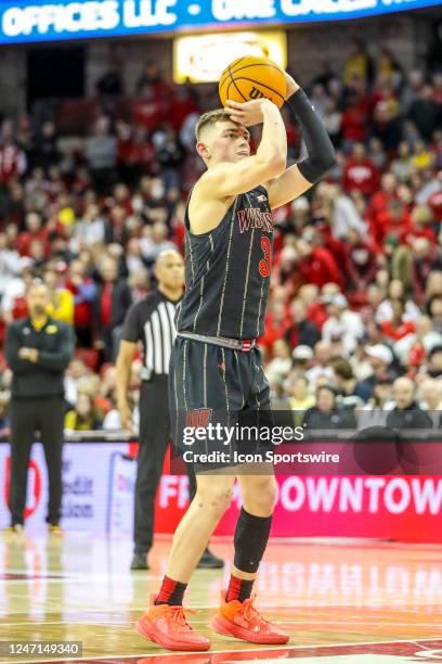 Wisconsin guard Connor Essegian shoots two free throws after Michigan head coach is called for a technical foul during a college basketball game...