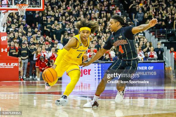 Michigan guard Dug McDaniel tries to get past Wisconsin guard Kamari McGee during a college basketball game between the University of Wisconsin...