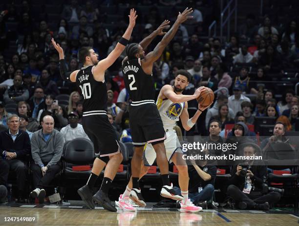 Klay Thompson of the Golden State Warriors looks to pass the ball against Kawhi Leonard and Ivica Zubac of the Los Angele Clippers during the first...