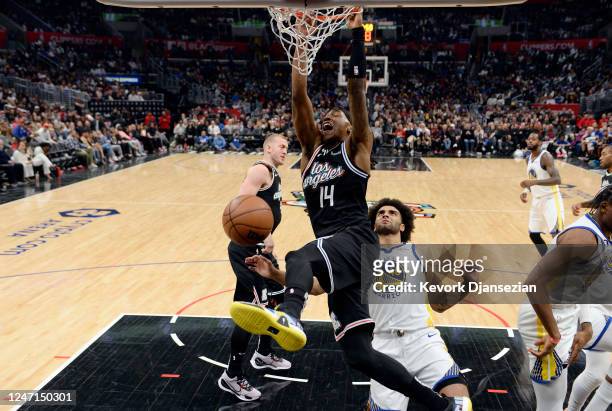 Terance Mann of the Los Angeles Clippers dunks against Anthony Lamb of the Golden State Warriors during the second half at Crypto.com Arena on...