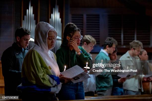 February 14: Amber Clark, left, and Anastachia Clark, a junior at Michigan State, react with emotion during the candlelight vigil at Eastminster...