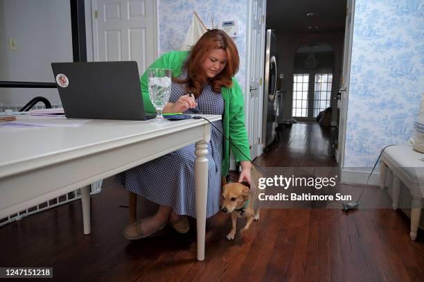 Petting one of her dogs, Paxton, while working from home Jan. 25 is doctoral student Alicia Castaneda Hatfield of University of Maryland School of...