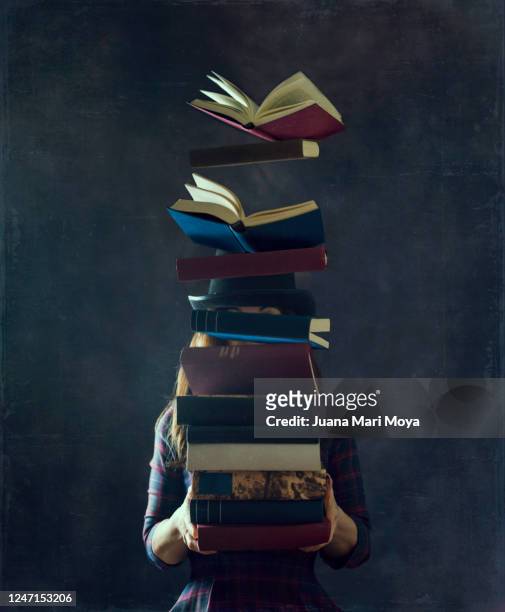 a woman in a top hat holds a large stack of books.  they cover her face and the books begin to fly. concept of wisdom, reading, culture, learning ... - clip art stockfoto's en -beelden