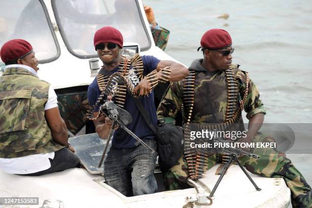 Partisans of Nigeria's key militant leaders in the volatile oil hub of the Niger Delta Ateke Tom arrive by boat to surrender arms on October 3, 2009...