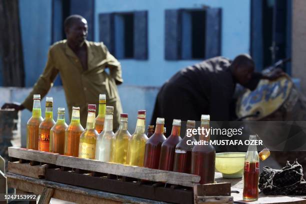 Nigerian man sells petrol at a black market at a pavement of a street in Maradi, southern city of Niger, on July 15, 2008. AFP PHOTO / MUSTAFA OZER