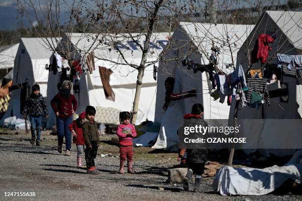Children walk in a camp for Syrian refugee in Turkey set up by Turkish relief agency AFAD in the Islahiye district of Gaziantep on February 15, 2023...