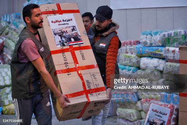 Iraqi volunteers gather aid and donations brought by Iraqis to be sent to Aleppo to help the victims of the February 6 earthquake that hit Turkey and...