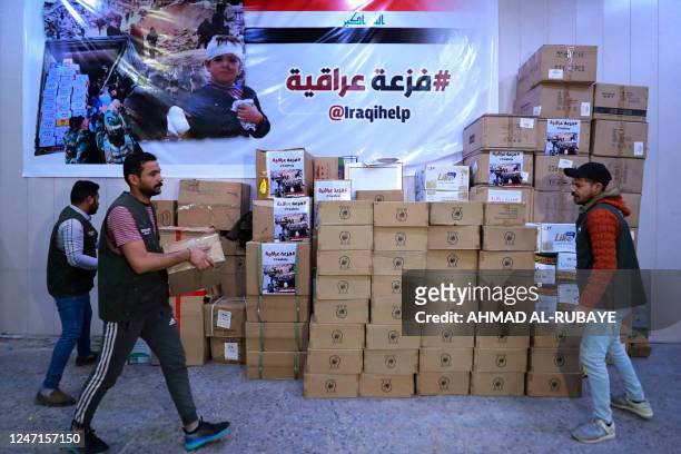 Iraqi volunteers gather aid and donations brought by Iraqis to be sent to Aleppo to help the victims of the February 6 earthquake that hit Turkey and...