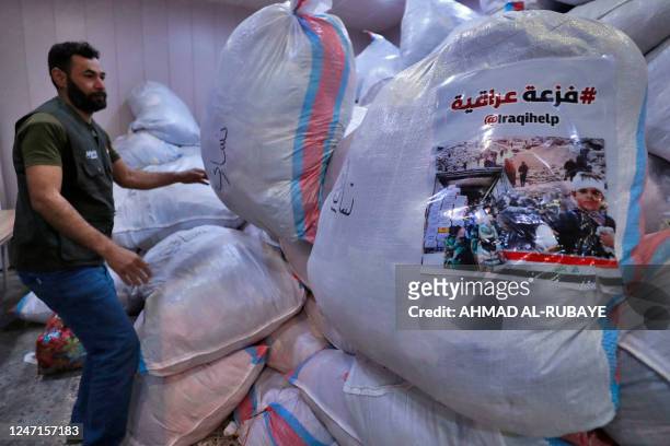 Iraqi volunteers gather aid and donations brought by Iraqis to be sent to Aleppo to help the victims of the February 6 earthquake that hit Turkey and...