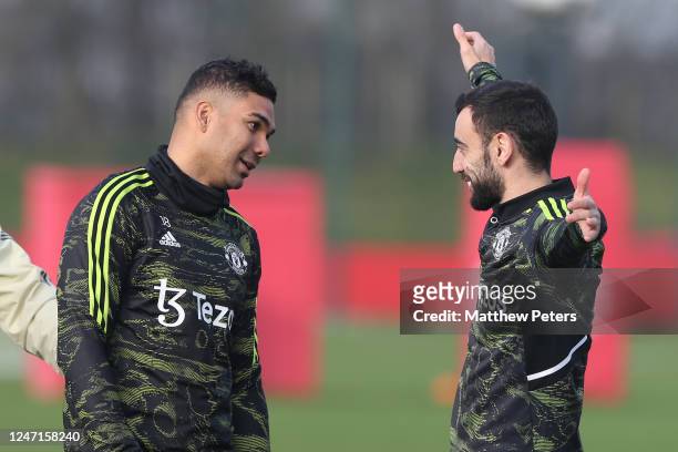 Bruno Fernandes of Manchester United reacts to Casemiro during a first team training session at Carrington Training Ground on February 15, 2023 in...
