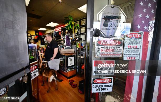 Signs are posted at the entrance to a gun shop owned by David Liu in Arcadia, California, on February 10, 2023. 6 percent of the US population...